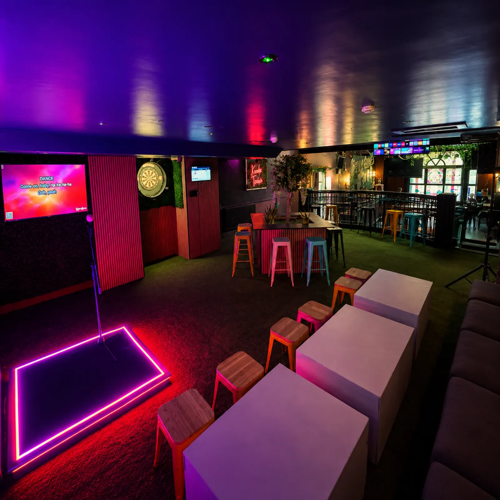 Karaoke Terrace neon stage and group seating at Plunkets Pub, Middle Abbey Street, Dublin city centre