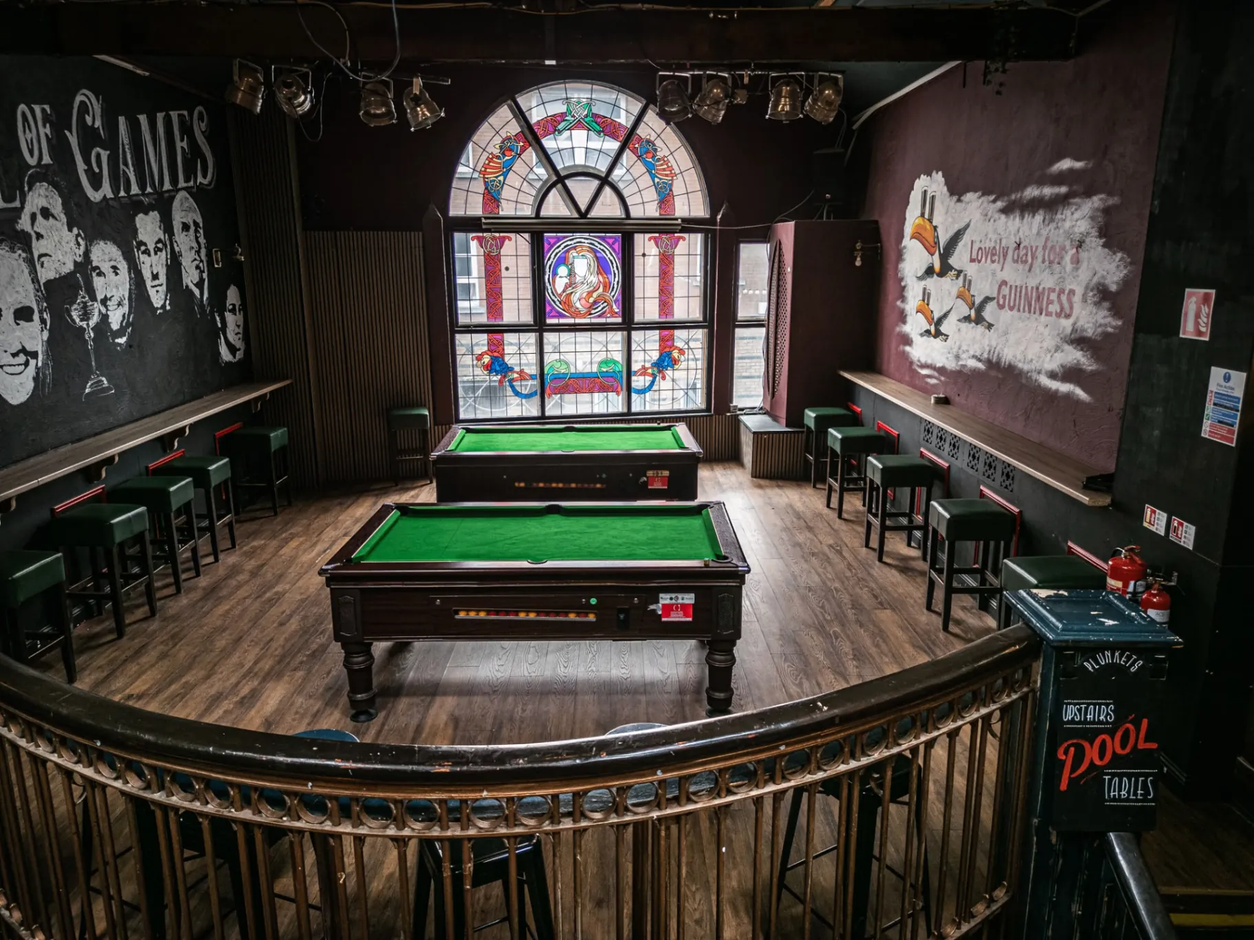 Upstairs pool tables under stained-glass windows at Plunkets Pub Dublin city centre